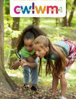 Two children looking through a magnifying glass