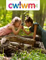 Two children looking at each other through magnifying glass